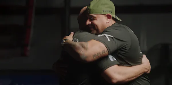 Two men hugging